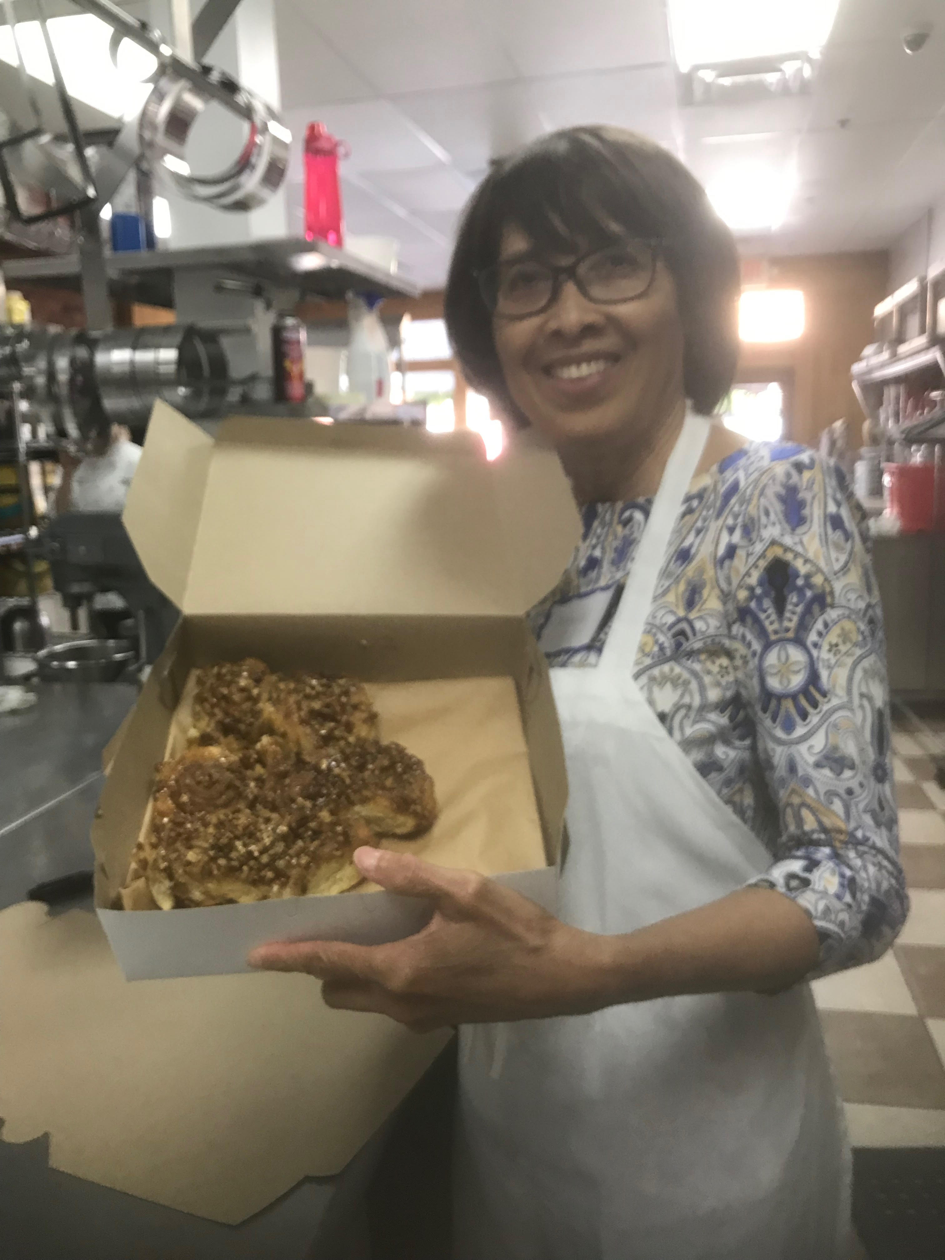 Alexis Niles showing off fresh-baked sticky buns.