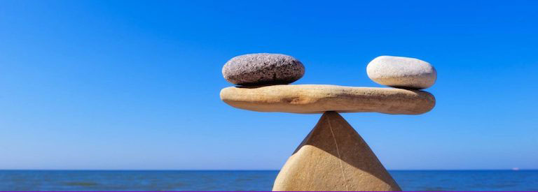 Wellness-balance image of rocks on a see-saw