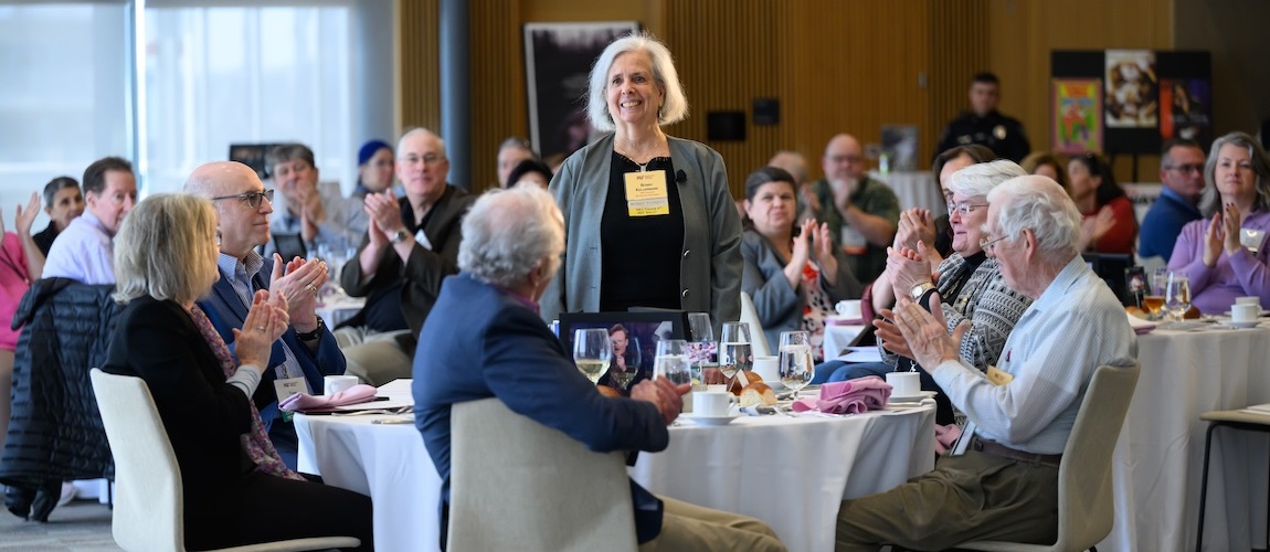 Assembled inductees celebrate a new member of the informal Gold Club of 50-year achievers.