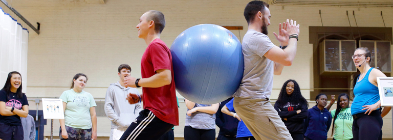 Group of people taking lessons on stability ball